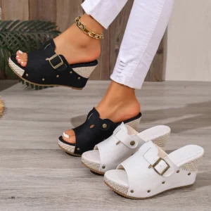 Woman wearing black wedge sandals with white pair