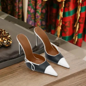 Pair of black-and-white pointed-toe mules