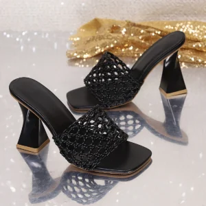 Black woven heeled mules with gold accent