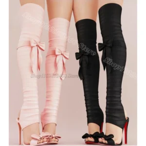 Pink and black thigh-high leg warmers with bows