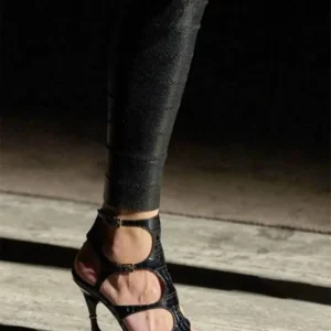 Black strappy high-heeled sandal on runway