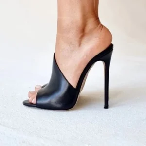 Black leather stiletto mule on woman's foot