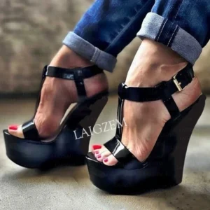Black patent platform wedge sandals with red pedicure