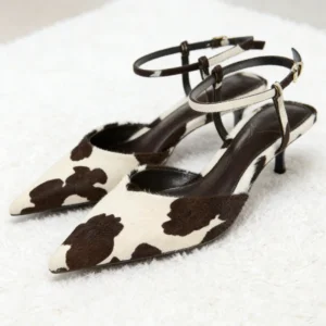 Cow-print pointed-toe ankle-strap kitten heels