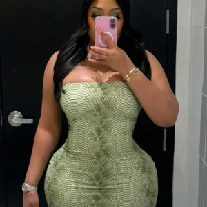 Woman mirror selfie wearing green textured mini dress