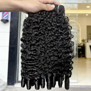 Hand holding curly black hair extensions