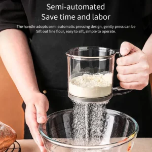 Hands using flour sifter over glass bowl
