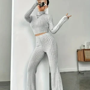 Person taking mirror selfie in gray ribbed outfit