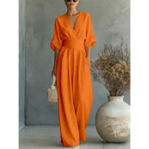 Woman in orange V-neck wide-leg jumpsuit